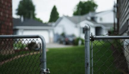 A fence showing neighbors who making it impossible to sell a house.
